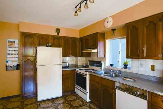 The existing kitchen work triangle is wedged into the corner.